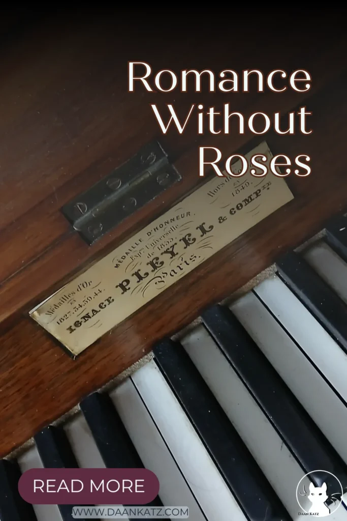 Close-up of an antique Pleyel piano. Text overlay says: Romance Without Roses