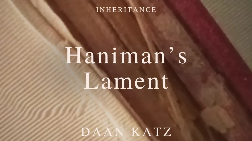 Close-up of a worn book spine with the text Inheritance -Haniman's Lament - Daan Katz overlaid in white capital letters.
