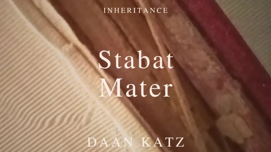 Close-up of a worn book spine with the text Inheritance -Stabat Mater - Daan Katz overlaid in white capital letters.
