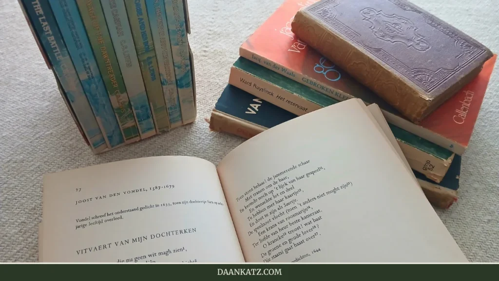An open book with Dutch text lies on a table surrounded by stacked and upright books, including classic literature, Dutch literature, and poetry, as well as enchanting fairy tales.